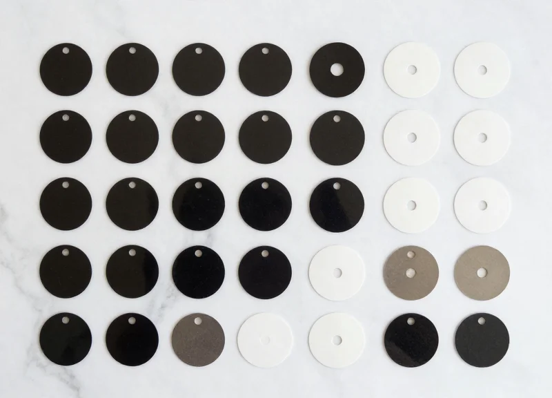 A flat lay of various security hard tags and soft labels neatly arranged.