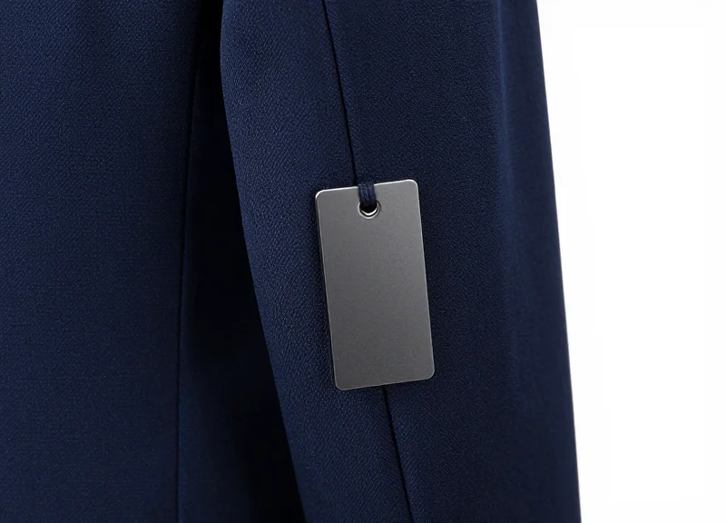 A discreet security tag attached to the sleeve of a premium blazer.