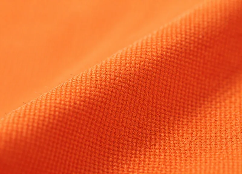 Close-up macro photography of heavy-duty flame-retardant fabric showing the detailed weave and fire-resistant texture.