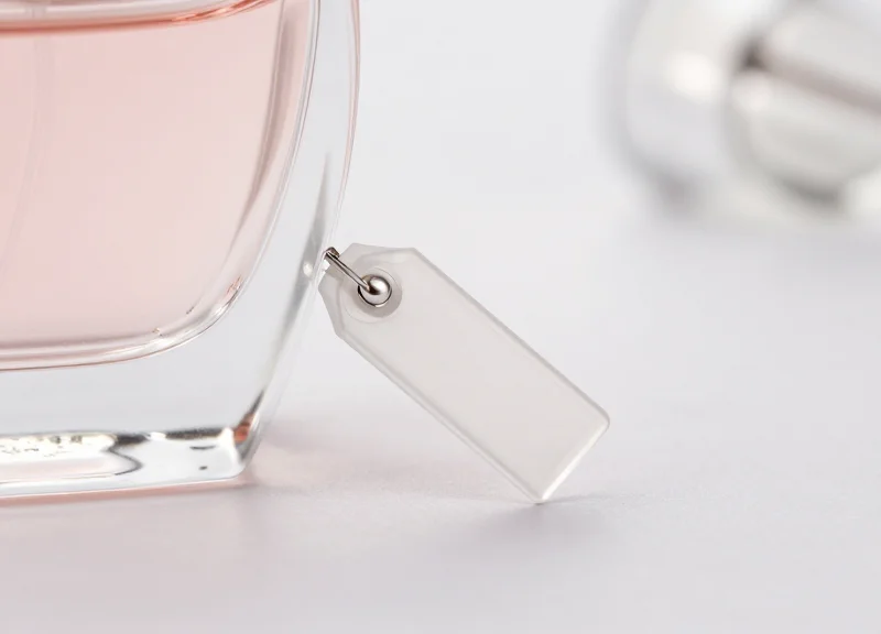 Close-up of a tiny, nearly invisible nano-tag on a luxury perfume bottle.