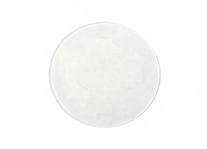 A 15mm circular transparent EAS label shown on a pure white background to highlight its thinness.