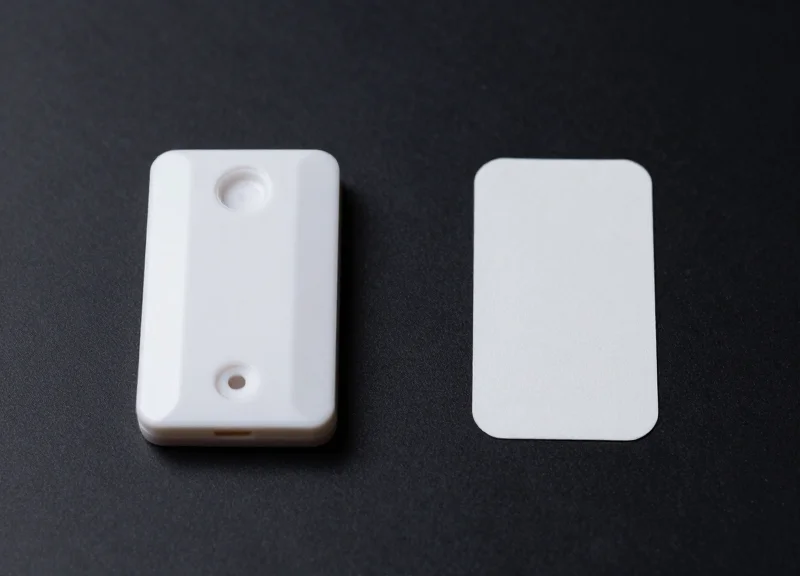 Side-by-side comparison of RF and AM electronic article surveillance tags for retail security.