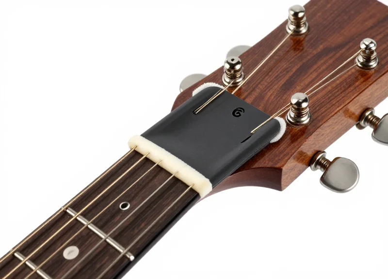Macro shot of a non-damaging security tag with soft padding attached to a guitar neck.