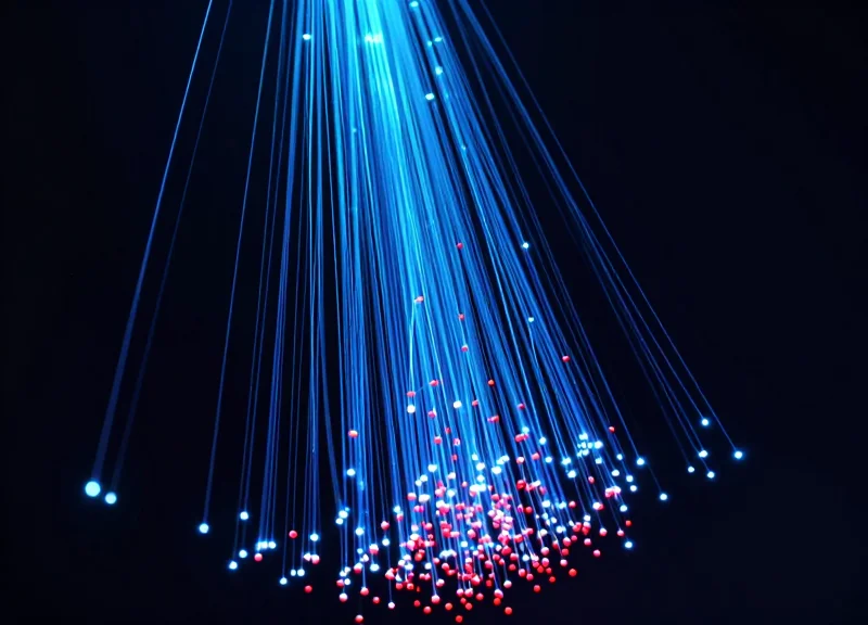 Abstract visualization of falling red nodes and rising blue light streams representing reduced shrinkage and increased revenue.