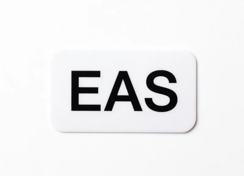 A single professional white EAS security label on a pure white background