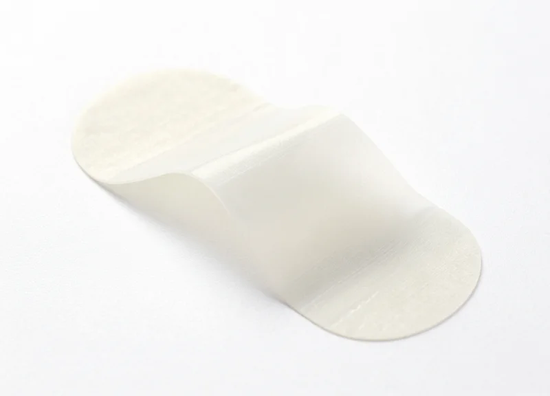 A close-up shot of a translucent pH-neutral security label showing its clean adhesive side