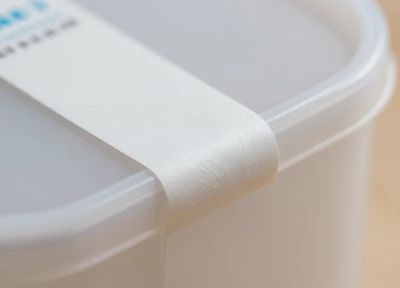Close-up of a security label adhering perfectly to a curved plastic bottle surface.