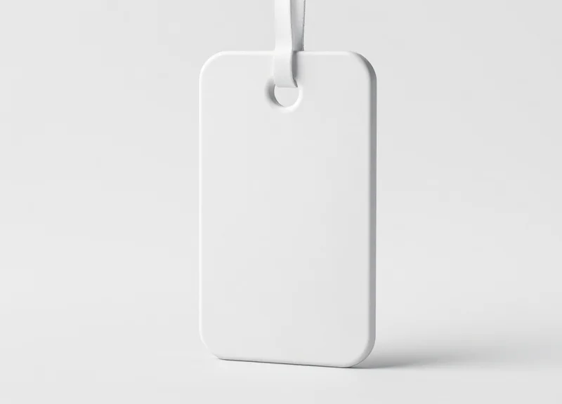 A professional close-up of a modern white electronic article surveillance security tag
