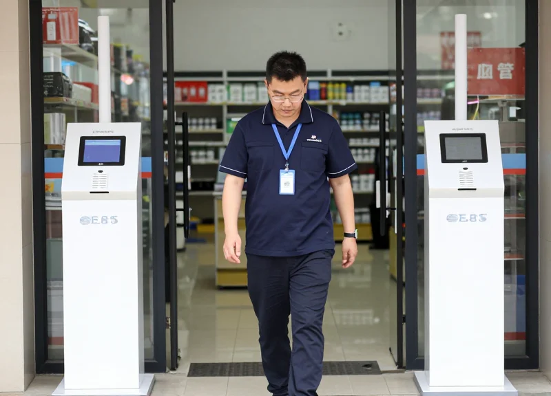Technician testing the detection range of security antennas with a retail tag.