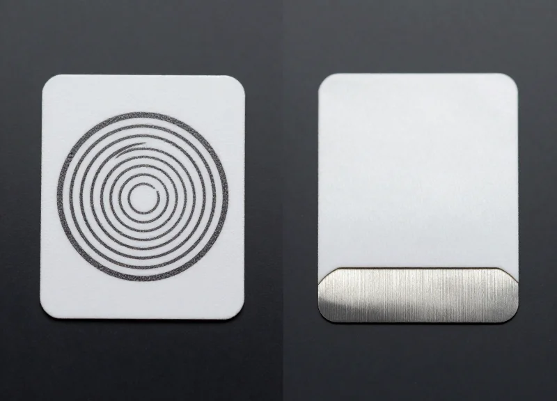 Comparison shot of two types of retail security tags side-by-side on a neutral grey background