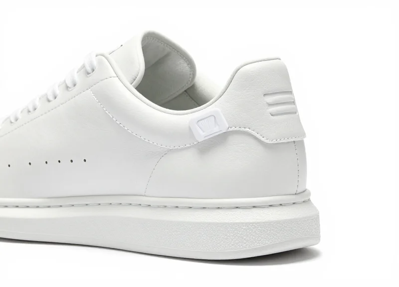 A close-up of a modern sneaker with a small RFID tag attached to the heel