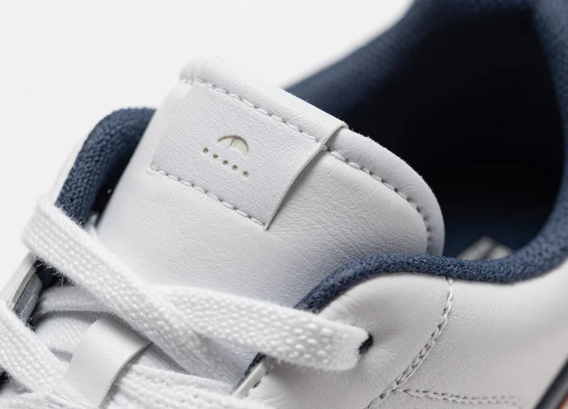 A close-up shot of a premium leather sneaker showing a small RFID tag subtly hidden in the inner tongue.