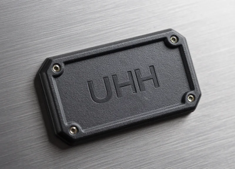 Macro shot of a rugged industrial UHF RFID tag designed for harsh chemical environments.