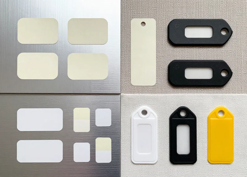 Various industrial RFID tags for baggage neatly arranged on different surface materials.