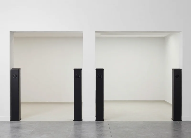 Side-by-side comparison of a store entrance with bulky pedestals versus a clean entrance with floor antennas.
