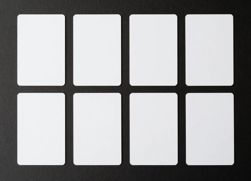 Top-down flat lay view of various RFID cards with different finishes and thicknesses organized on a clean surface.