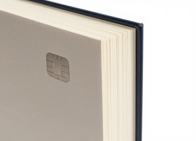 A close-up shot of a library book with a transparent RFID tag visible on the inside cover