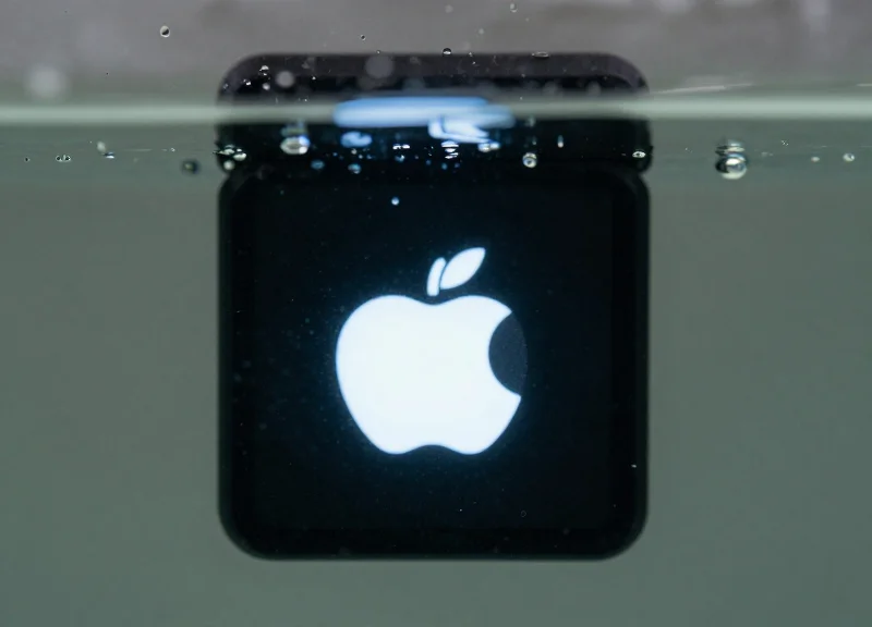 A high-tech electronic shelf label submerged in clear water to demonstrate IP68 waterproof rating.