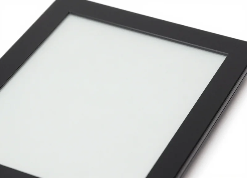 Close-up of a high-resolution e-ink digital display panel showing a blank screen with a minimalist frame