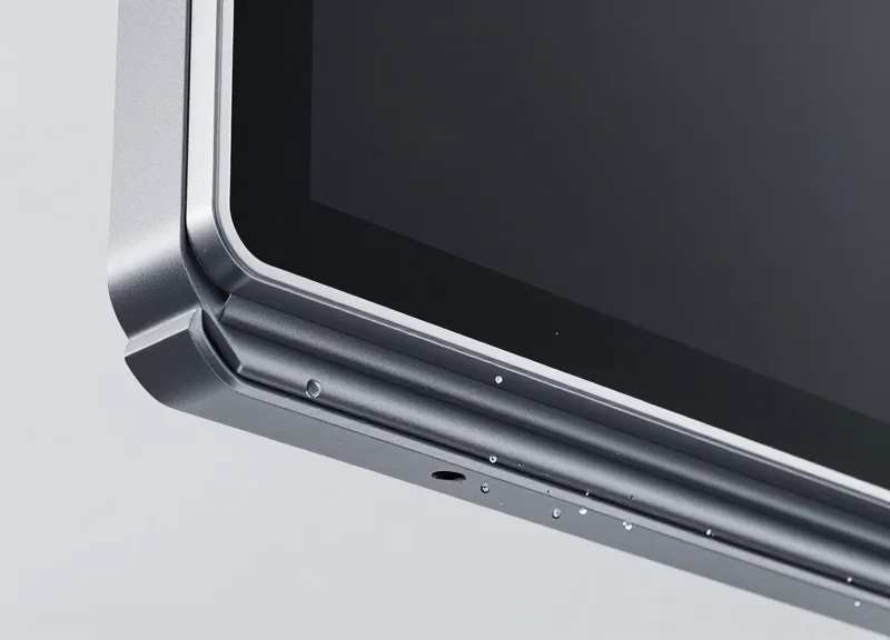 Close-up of a rugged electronic shelf label being splashed with water and covered in dust to demonstrate IP68 sealing.