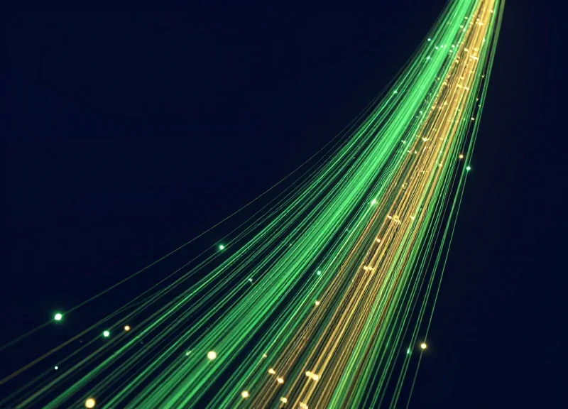 Abstract data visualization showing upward trending light trails representing return on investment and cost savings.